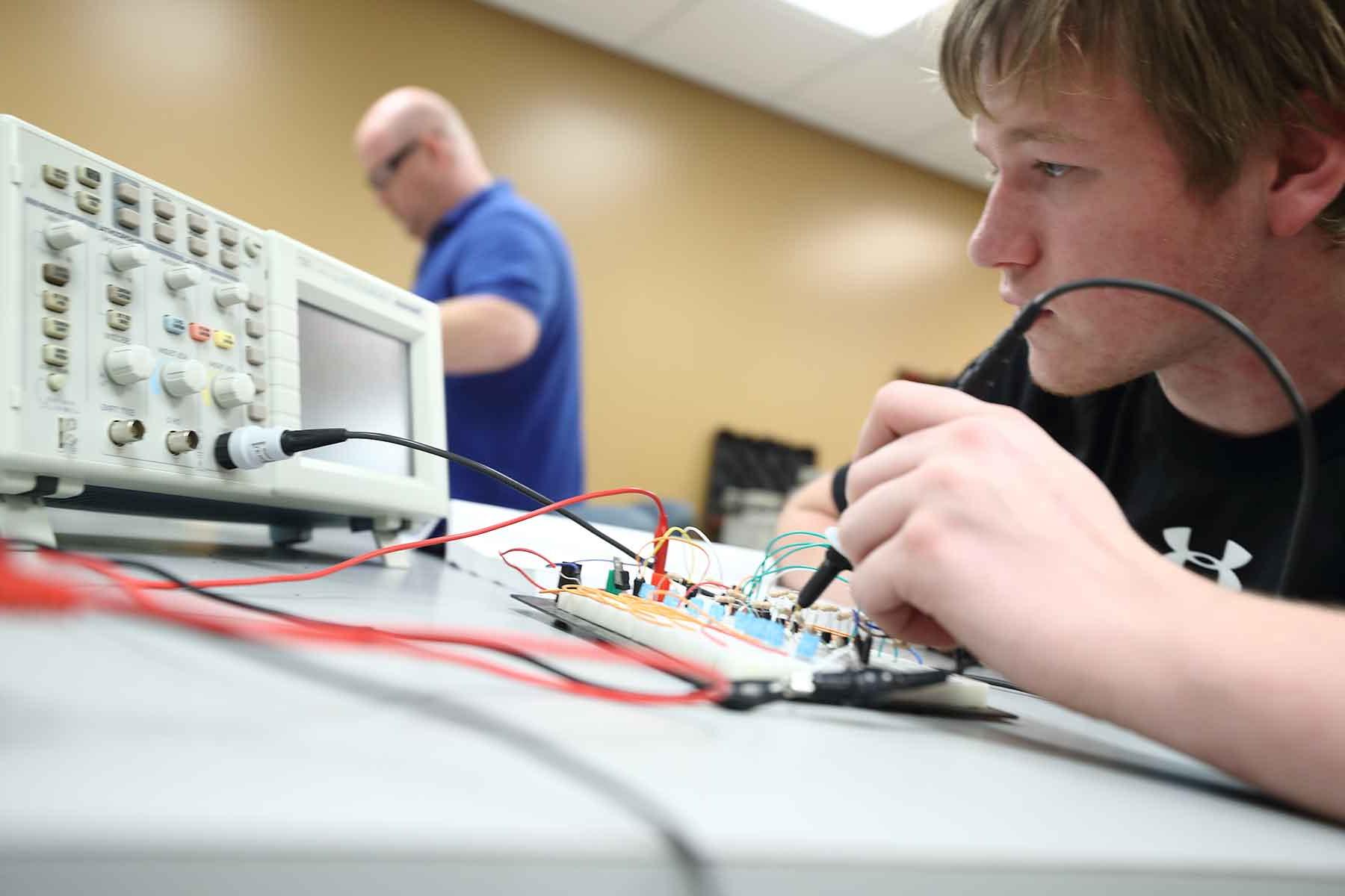 Electronics student testing board